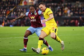 BURNLEY, ENGLAND - DECEMBER 02: Jack Robinson of Sheffield United battles for possession with Michael Obafemi of Burnley during the Premier League match between Burnley FC and Sheffield United at Turf Moor on December 02, 2023 in Burnley, England. (Photo by Matt McNulty/Getty Images)