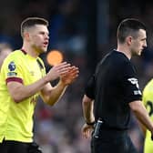 LONDON, ENGLAND - FEBRUARY 24: Johann Gudmundsson of Burnley talks to Referee, Lewis Smith during the Premier League match between Crystal Palace and Burnley FC at Selhurst Park on February 24, 2024 in London, England. (Photo by Alex Davidson/Getty Images)
