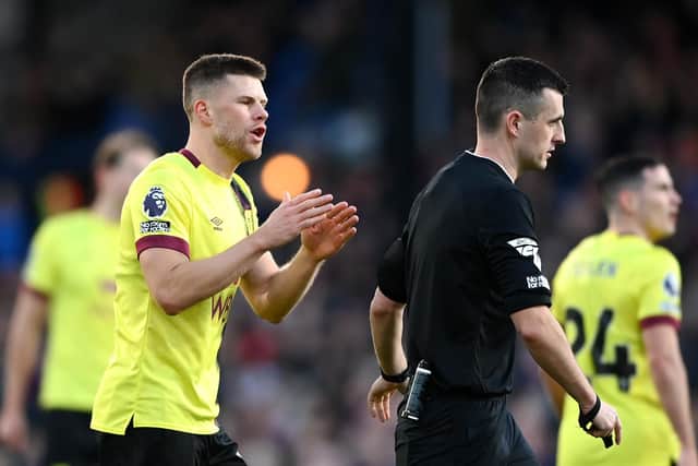 LONDON, ENGLAND - FEBRUARY 24: Johann Gudmundsson of Burnley talks to Referee, Lewis Smith during the Premier League match between Crystal Palace and Burnley FC at Selhurst Park on February 24, 2024 in London, England. (Photo by Alex Davidson/Getty Images)