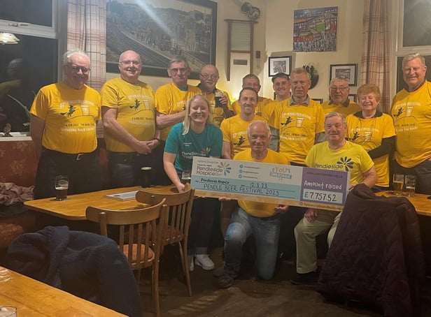 Leah Hooper with members of East Lancs CAMRA receiving the cheque at The Admiral Lord Rodney