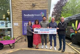 Proudly presenting the cheque to  Pendleside Hospice for the cash raised during a 10k walk organised by Burnley company PEMFIT