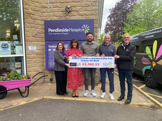 Proudly presenting the cheque to Pendleside Hospice for the cash raised during a 10k walk organised by Burnley company PEMFIT