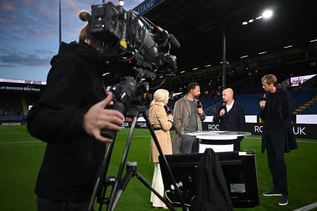 Manchester United's Dutch manager Erik ten Hag (2R) gives an interview to TNT Sports ahead of the English Premier League football match between Burnley and Manchester United at Turf Moor in Burnley, north-west England on September 23, 2023. (Photo by Paul ELLIS / AFP) / RESTRICTED TO EDITORIAL USE. No use with unauthorized audio, video, data, fixture lists, club/league logos or 'live' services. Online in-match use limited to 120 images. An additional 40 images may be used in extra time. No video emulation. Social media in-match use limited to 120 images. An additional 40 images may be used in extra time. No use in betting publications, games or single club/league/player publications. /  (Photo by PAUL ELLIS/AFP via Getty Images)
