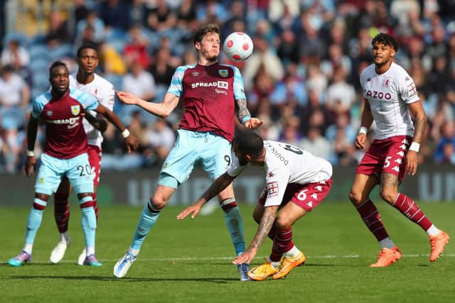 BURNLEY, ENGLAND - MAY 07: Wout Weghorst of Burnley controls the ball under pressure from Douglas Luiz of Aston Villa during the Premier League match between Burnley and Aston Villa at Turf Moor on May 07, 2022 in Burnley, England. (Photo by Alex Livesey/Getty Images)