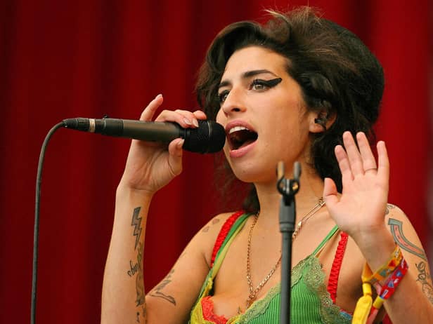 Pilton, UNITED KINGDOM: British pop singer Amy Winehouse performs at the Glastonbury music festival, in Pilton, Somerset, in south-west England, 22 June 2007. (Photo by CARL DE SOUZA/AFP via Getty Images)