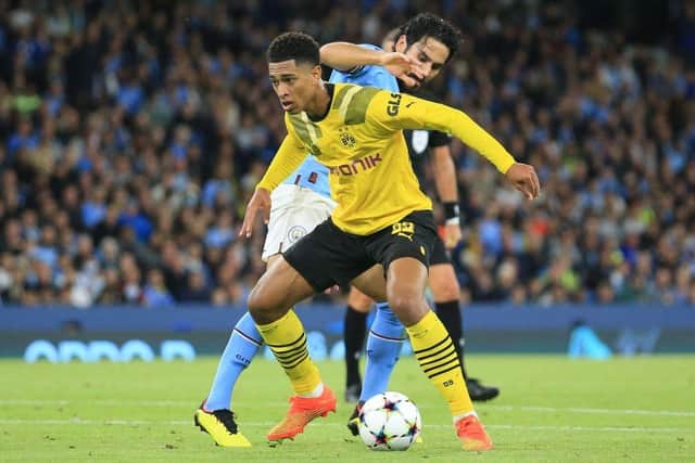 Dortmund's English midfielder Jude Bellingham vies for the ball with Manchester City's German midfielder Ilkay Gundogan (background) during the UEFA Champions League group G football match between England's Manchester City and Germany's Borussia Dortmund at the Etihad Stadium in Manchester on September 14, 2022. (Photo by Lindsey Parnaby / AFP) (Photo by LINDSEY PARNABY/AFP via Getty Images)