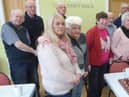 The Monday at One group celebrate with a birthday cake containing ten candles – one for each ten of Terry’s 100 years.