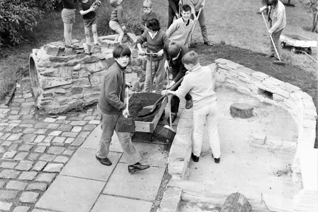 Teenage boys, volunteers from Coal Clough Special School, transformed a waste area at Howard Street Nursery School into a kiddies' paradise. Under the leadership of deputy headmaster Mr William Frederick Smith, they made a paved sandpit and play area from paving stones, concrete, crazy paving and cemented insets.