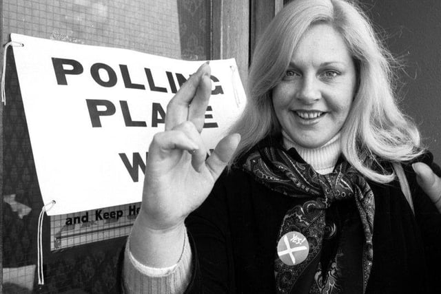 SNP politician Margo MacDonald keeps her fingers crossed at a polling station in Glasgow during the referendum vote on Scottish devolution in March 1979.