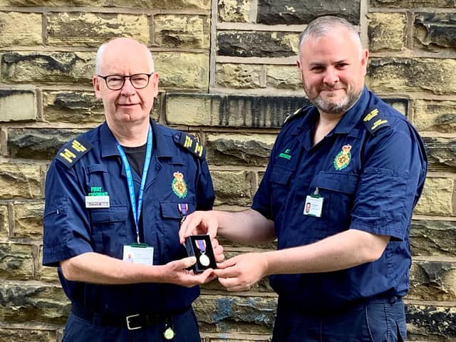 NWAS First Responder David Brown presenting Pendle MP Andrew Stephenson with his Platinum Jubilee long service medal