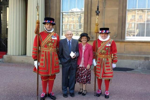 Mr Colin Wills receiving his MBE with wife Freda at Buckingham Palace in 2016