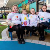 Pupils from Cherry Fold school enjoying a sit on the bench in the sensory walkway in Burnley Town Centre. Photo: Kelvin Stuttard