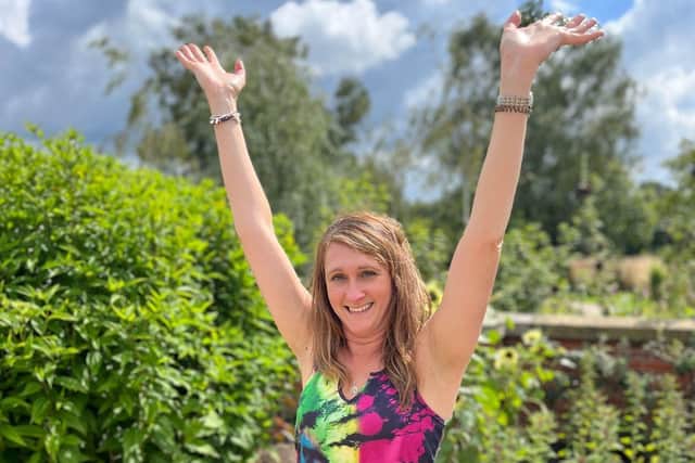 Joanne Edwards, co-founder of Friends of Serenity, demonstrates the "tree pose".