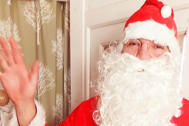 Burnley man, Getty Schinkel, dressed up as Santa while visiting children in need.
