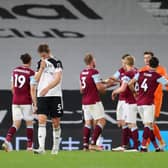 LONDON, ENGLAND - MAY 10: Joachim Andersen (L) of Fulham looks dejected after defeat as Fulham are relegated following the Premier League match between Fulham and Burnley at Craven Cottage on May 10, 2021 in London, England. Sporting stadiums around the UK remain under strict restrictions due to the Coronavirus Pandemic as Government social distancing laws prohibit fans inside venues resulting in games being played behind closed doors. (Photo by Catherine Ivill/Getty Images)