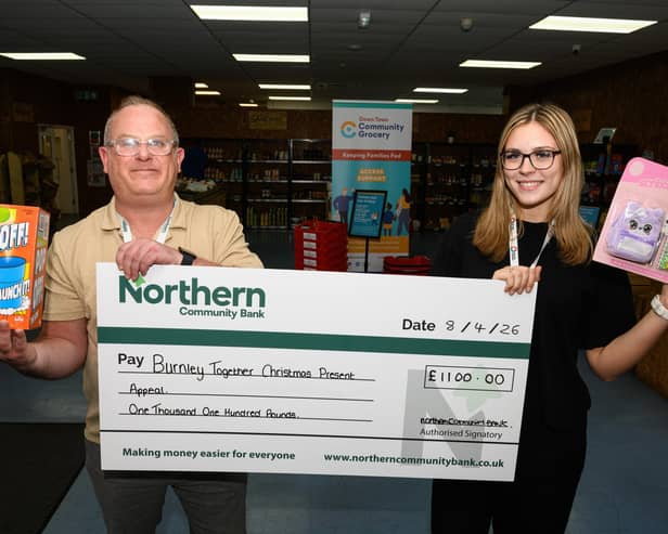 Ella Roberts, senior customer service advisor with Burnley Together, who runs the Christmas Present Appeal, receives a cheque from Lee Banks, development officer at Northern Community Bank