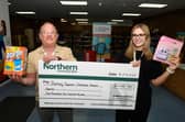 Ella Roberts, senior customer service advisor with Burnley Together, who runs the Christmas Present Appeal, receives a cheque from Lee Banks, development officer at Northern Community Bank