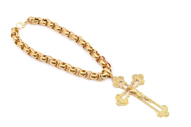 Giant 1.5 kilo 9ct gold and cross chain, estimate £30k. See SWNS story SWMRcross; The biggest gold crucifix and chain in the UK which weighs 1.5kg is set to fetch £30k at auction - with bling-loving boxers Tyson Fury and Anthony Joshua being offered first dibs.