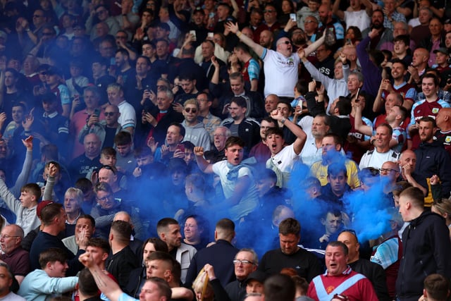 WATFORD, ENGLAND - APRIL 30: Burnley fans celebrate after their sides second goal during the Premier League match between Watford and Burnley at Vicarage Road on April 30, 2022 in Watford, England. (Photo by Julian Finney/Getty Images)