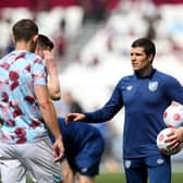 LONDON, ENGLAND - APRIL 17: Mike Jackson, Caretaker Manager of Burnley, interacts with players as they warm up prior to the Premier League match between West Ham United and Burnley at London Stadium on April 17, 2022 in London, England. (Photo by Steve Bardens/Getty Images)