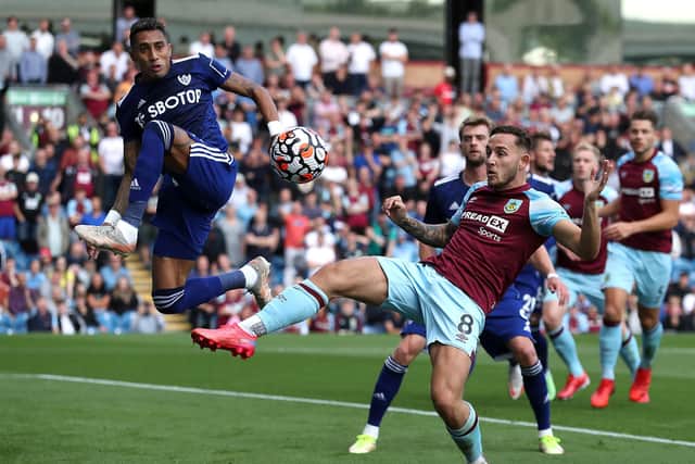 BURNLEY, ENGLAND - AUGUST 29: Raphinha of Leeds United battles for possession with Josh Brownhill of Burnley  during the Premier League match between Burnley and Leeds United at Turf Moor on August 29, 2021 in Burnley, England. (Photo by Jan Kruger/Getty Images)