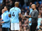 MANCHESTER, ENGLAND - OCTOBER 20:  Josep Guardiola, Manager of Manchester City speaks with Vincent Kompany of Manchester City during the Premier League match between Manchester City and Burnley FC at Etihad Stadium on October 20, 2018 in Manchester, United Kingdom.  (Photo by Shaun Botterill/Getty Images)