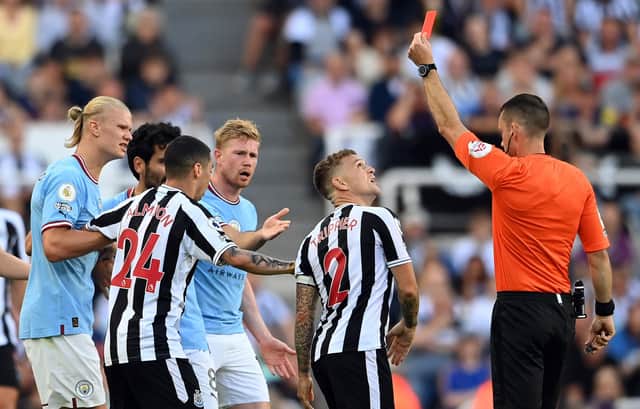 NEWCASTLE UPON TYNE, ENGLAND - AUGUST 21: Kieran Trippier of Newcastle United is shown a red card by referee Jarred Gillett which is later overturned to a yellow card  during the Premier League match between Newcastle United and Manchester City at St. James Park on August 21, 2022 in Newcastle upon Tyne, England. (Photo by Stu Forster/Getty Images)