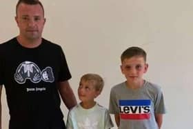 Dedicated grassroots football coach Gaz Edwards with his two sons Colby (seven) and Theo (12)