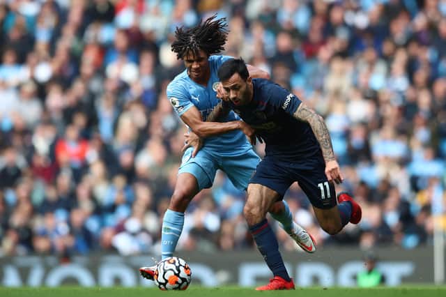 MANCHESTER, ENGLAND - OCTOBER 16: Dwight McNeil of Burnley and Nathan Ake of Manchester City battle for the ball during the Premier League match between Manchester City and Burnley at Etihad Stadium on October 16, 2021 in Manchester, England. (Photo by Jan Kruger/Getty Images)