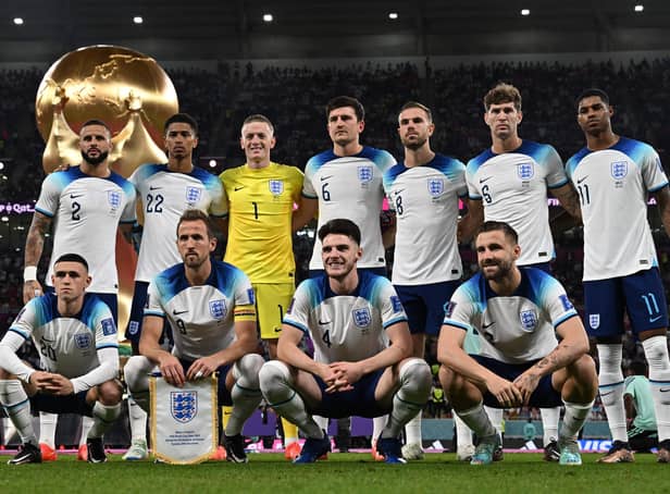 <p>England players pose for a squad photo ahead of their Group B clash with Wales - with a 3-0 victory in the game setting up a last-16 tie with Senegal. (Photo by PAUL ELLIS/AFP via Getty Images)</p>