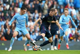MANCHESTER, ENGLAND - OCTOBER 16: Phil Foden of Manchester City battles for possession with Nathan Collins of Burnley during the Premier League match between Manchester City and Burnley at Etihad Stadium on October 16, 2021 in Manchester, England. (Photo by Alex Livesey/Getty Images)