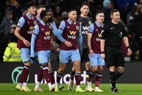 English Referee Tony Harrington (R) is followed by Burnley players as the VAR (Video Assistant Referee) is asked to look at the late Luton goal during the English Premier League football match between Burnley and Luton Town at Turf Moor in Burnley, north-west England on January 12, 2024. (Photo by Oli SCARFF / AFP) / RESTRICTED TO EDITORIAL USE. No use with unauthorized audio, video, data, fixture lists, club/league logos or 'live' services. Online in-match use limited to 120 images. An additional 40 images may be used in extra time. No video emulation. Social media in-match use limited to 120 images. An additional 40 images may be used in extra time. No use in betting publications, games or single club/league/player publications. /  (Photo by OLI SCARFF/AFP via Getty Images)
