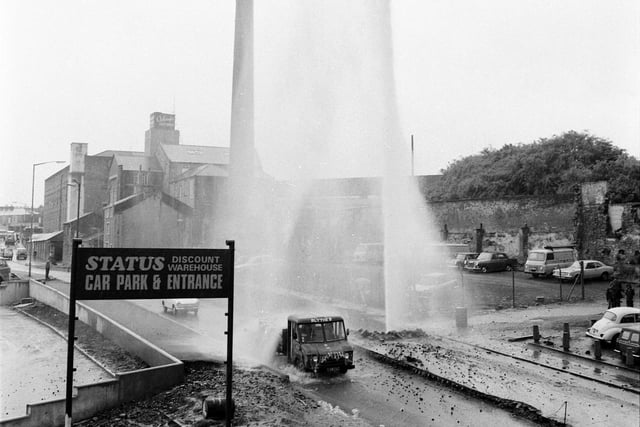Finsley Gate, Burnley. June 22, 1973.

A major disaster was averted after a 60-foot high fountain of water shot into the air when an excavator snapped off the valve to the mains under Finsley Gate this week. The roadway became a torrent, Calder Water Board engineers struggled to turn off the supply. Within 15 minutes the 18-inch trunk main water pipe was under control, thanks to a lucky coincidence. "It just so happened that we had a spare valve in stock. We aren't always prepared for a major burst like this" said a water board spokesman. He described the burst, which cut off water supplies in the immediate area for more than two hours, as very serious. "If we hadn't had the spare in stock, it could have taken months to repair the main" he said.
Water burst from the mains when the driver of the excavator accidentally pulled off the concealed cap to the valve. But no one was near the pipe when it burst and no one was injured. But as the fountain soared into the air, some cars continued to travel along the road, despite falling rubble and soil.