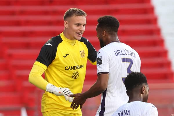 Anderlecht's goalkeeper Bart Verbruggen and Anderlecht's Hannes Delcroix celebrate after winning a soccer match between RAFC Antwerp and RSC Anderlecht, Sunday 08 May 2022 in Antwerp, on day 3 of the Champions' play-offs of the 2021-2022 'Jupiler Pro League' first division of the Belgian championship. BELGA PHOTO VIRGINIE LEFOUR (Photo by VIRGINIE LEFOUR / BELGA MAG / Belga via AFP) (Photo by VIRGINIE LEFOUR/BELGA MAG/AFP via Getty Images)