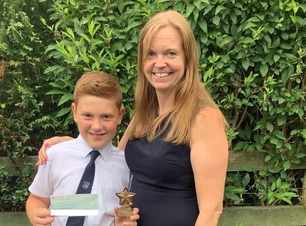 Enterprising George Greenwood, a year six pupil at St Leonard's C of E School in Langho, raised £233 for UNICEF all on his own. He is pictured here with his proud headteacher Dawn Lindley.