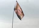 The flag above the main stage at Glastonbury bearing the face of Burnley man Kev Riley also known  as 'The Whisk Guy'
