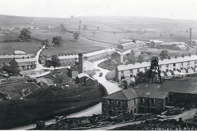 The village of Walk Mill showing that it was an industrial village in the early twentieth century, which was dominated by the coal industry. On the left is the Cliviger, or Union, Colliery, with, above it, the Railway Colliery, which was part of the Union Mine. On the extreme right, is Walk Mill’s only cotton mill. Centre, the square chimney is an air shaft used by the Cliviger Colliery, with another just above it in the fields. Note the terraced houses of the industrial period.