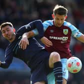 BURNLEY, ENGLAND - APRIL 02: Aymeric Laporte of Manchester City battles for possession with James Tarkowski of Burnley  during the Premier League match between Burnley and Manchester City at Turf Moor on April 02, 2022 in Burnley, England. (Photo by Alex Livesey/Getty Images)