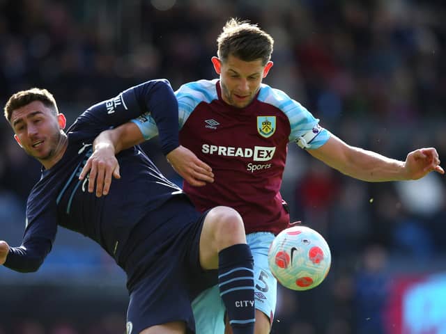 BURNLEY, ENGLAND - APRIL 02: Aymeric Laporte of Manchester City battles for possession with James Tarkowski of Burnley  during the Premier League match between Burnley and Manchester City at Turf Moor on April 02, 2022 in Burnley, England. (Photo by Alex Livesey/Getty Images)