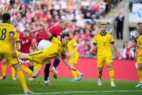 Norway's forward Erling Braut Haaland (C) gets to the ball ahead of Sweden's defender Hjalmar Ekdal to score the opening goal during the UEFA Nations League football match Norway v Sweden in Oslo, Norway, on June 12, 2022. - - Norway OUT (Photo by Javad Parsa / NTB / AFP) / Norway OUT (Photo by JAVAD PARSA/NTB/AFP via Getty Images)