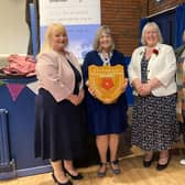 Linda Sawley receives her trophy from Victoria Mitchell and Debby Swain of the Rolling Scones WI, and Heather Williams, president of the Lancashire Federation of the WI