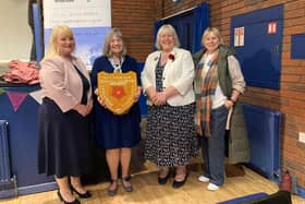 Linda Sawley receives her trophy from Victoria Mitchell and Debby Swain of the Rolling Scones WI, and Heather Williams, president of the Lancashire Federation of the WI