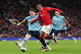 MANCHESTER, ENGLAND - DECEMBER 21: Marcus Rashford of Manchester United is challenged by Taylor Harwood-Bellis of Burnley during the Carabao Cup Fourth Round match between Manchester United and Burnley at Old Trafford on December 21, 2022 in Manchester, England. (Photo by Jan Kruger/Getty Images)