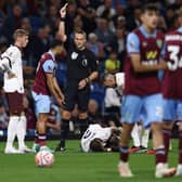 Burnley's Belgian striker #19 Anass Zaroury (2nd L) reacts after receiving a yellow card following a foul he committed on Manchester City's English defender #02 Kyle Walker during the English Premier League football match between Burnley and Manchester City at Turf Moor in Burnley, north-west England on August 11, 2023. (Photo by Darren Staples / AFP) / RESTRICTED TO EDITORIAL USE. No use with unauthorized audio, video, data, fixture lists, club/league logos or 'live' services. Online in-match use limited to 120 images. An additional 40 images may be used in extra time. No video emulation. Social media in-match use limited to 120 images. An additional 40 images may be used in extra time. No use in betting publications, games or single club/league/player publications. /  (Photo by DARREN STAPLES/AFP via Getty Images)