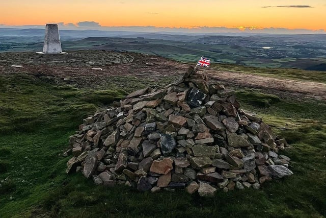 A solitary Union Jack flag placed in a pile of stones at the top of Pendle Hill is a moving tribute to the Queen