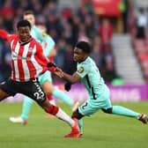 SOUTHAMPTON, ENGLAND - DECEMBER 04: Nathan Tella of Southampton is challenged by Tariq Lamptey of Brighton & Hove Albion during the Premier League match between Southampton and Brighton & Hove Albion at St Mary's Stadium on December 04, 2021 in Southampton, England. (Photo by Michael Steele/Getty Images)