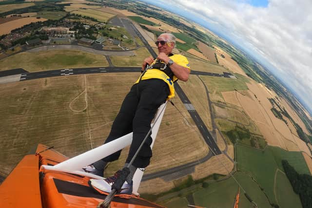This amazing shot shows Ivor Emo mid flight on his wing walk to raise cash for the North West Air Ambulance charity