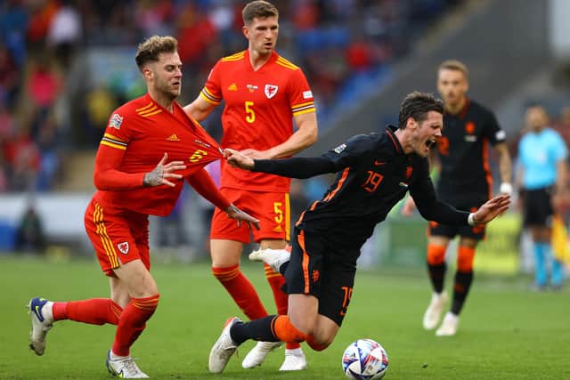 CARDIFF, WALES - JUNE 08:  Joe Rodon of Wales battles for possession with Wout Weghorst of Netherlands during the UEFA Nations League League A Group 4 match between Wales and Netherlands  at Cardiff City Stadium on June 08, 2022 in Cardiff, Wales. (Photo by Michael Steele/Getty Images)