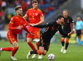 CARDIFF, WALES - JUNE 08:  Joe Rodon of Wales battles for possession with Wout Weghorst of Netherlands during the UEFA Nations League League A Group 4 match between Wales and Netherlands  at Cardiff City Stadium on June 08, 2022 in Cardiff, Wales. (Photo by Michael Steele/Getty Images)