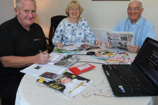 Burnley Talking Newspaper volunteers Alan and Marjorie Dunderdale and Brian Horne preparing the next edition for listeners